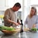 A couple preparing a meal together with fresh vegetables in a modern kitchen